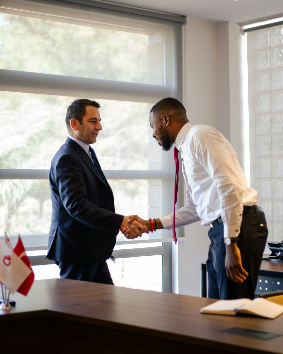 Company director shaking hands with a new employee benefits broker
